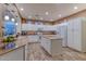 Bright kitchen with white cabinets, granite countertops, and stainless steel appliances at 3604 N 162Nd Ave, Goodyear, AZ 85395