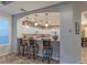 Kitchen features a breakfast bar with seating and white cabinets at 3604 N 162Nd Ave, Goodyear, AZ 85395