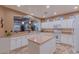 Spacious kitchen with an island, white cabinets, and granite countertops at 3604 N 162Nd Ave, Goodyear, AZ 85395