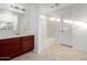 Bathroom features a cherry vanity cabinet, white countertop, tiled floors, and a shower-tub combo at 4044 E Oakland St, Gilbert, AZ 85295