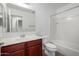 Bright bathroom with cherry vanity, and shower and tub combination at 4044 E Oakland St, Gilbert, AZ 85295