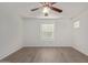 Bright bedroom with ceiling fan, large window, and wood-look floors at 4044 E Oakland St, Gilbert, AZ 85295