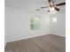 Bright bedroom features neutral walls, ceiling fan, wood-look floors, and a window at 4044 E Oakland St, Gilbert, AZ 85295