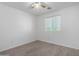 Bright bedroom features neutral walls, ceiling fan, wood-look floors, and a window at 4044 E Oakland St, Gilbert, AZ 85295