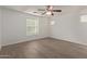 Bright bedroom with ceiling fan, large window, and wood-look floors at 4044 E Oakland St, Gilbert, AZ 85295