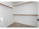 Bright walk-in closet with two rows of clothing rods and wood-look flooring at 4044 E Oakland St, Gilbert, AZ 85295