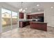 Modern kitchen with dark wood cabinets and tiled floor at 4044 E Oakland St, Gilbert, AZ 85295