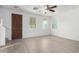 Bright living room featuring wood-look floors, ceiling fan, and natural light from the many windows at 4044 E Oakland St, Gilbert, AZ 85295