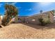 Backyard featuring a dirt landscape with a block wall fence and greenery at 4124 N 105Th Ln, Phoenix, AZ 85037