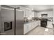 Spacious kitchen featuring white cabinets, black appliances, tile backsplash and tile floors at 4124 N 105Th Ln, Phoenix, AZ 85037