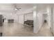 Open-concept living room featuring tile floors, neutral paint, ceiling fan, and flows into the kitchen at 4124 N 105Th Ln, Phoenix, AZ 85037