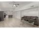 Open-concept living room featuring tile floors, neutral paint, ceiling fan, and flows into the dining area at 4124 N 105Th Ln, Phoenix, AZ 85037