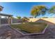 Landscaped backyard with grassy area and block wall at 4322 E South Fork Dr, Phoenix, AZ 85044