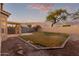 Landscaped backyard with grassy area and block wall at 4322 E South Fork Dr, Phoenix, AZ 85044