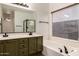 Modern bathroom with double vanity, bathtub, and shower at 4322 E South Fork Dr, Phoenix, AZ 85044