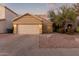 Tan house with two-car garage and desert landscaping at 4322 E South Fork Dr, Phoenix, AZ 85044