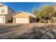 Tan house with two-car garage and desert landscaping at 4322 E South Fork Dr, Phoenix, AZ 85044