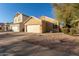 Tan house with two-car garage and desert landscaping at 4322 E South Fork Dr, Phoenix, AZ 85044