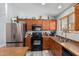 Modern kitchen with stainless steel appliances and wood cabinets at 45579 W Rainbow Dr, Maricopa, AZ 85139