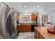 Stainless steel appliances and wood cabinets in this kitchen at 45579 W Rainbow Dr, Maricopa, AZ 85139