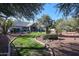 Landscaped backyard with grassy areas and mature trees at 5432 W Fallen Leaf Ln, Glendale, AZ 85310