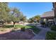 Landscaped backyard oasis featuring a sparkling pool, patio, and lush greenery at 5432 W Fallen Leaf Ln, Glendale, AZ 85310