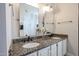 Double vanity bathroom with granite countertops and large mirrors at 5432 W Fallen Leaf Ln, Glendale, AZ 85310