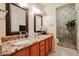 Double vanity bathroom with granite countertop and shower at 5432 W Fallen Leaf Ln, Glendale, AZ 85310