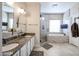 Double vanity bathroom with granite countertops and updated fixtures at 5432 W Fallen Leaf Ln, Glendale, AZ 85310