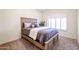 Well-lit bedroom with wood bed frame and window shutters at 5432 W Fallen Leaf Ln, Glendale, AZ 85310