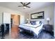 Main bedroom with dark wood floors and large mirror at 5432 W Fallen Leaf Ln, Glendale, AZ 85310