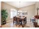 A formal dining room with a wood table, chairs, and stylish light fixture at 5432 W Fallen Leaf Ln, Glendale, AZ 85310