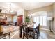 Bright dining room features a wood table with seating for six and a view to the living room at 5432 W Fallen Leaf Ln, Glendale, AZ 85310