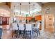 Open kitchen with island seating, stainless steel appliances, and hardwood floors at 5432 W Fallen Leaf Ln, Glendale, AZ 85310