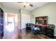 Home office with built-in shelving and hardwood floors at 5432 W Fallen Leaf Ln, Glendale, AZ 85310