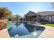 Stunning pool and spa surrounded by a spacious patio and lush landscaping at 5432 W Fallen Leaf Ln, Glendale, AZ 85310