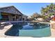 Relaxing pool area with stone patio, lounge chairs, and mountain views at 5432 W Fallen Leaf Ln, Glendale, AZ 85310