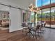 Modern dining room with sliding barn door and view to backyard at 6525 E Cave Creek Rd # 14, Cave Creek, AZ 85331