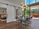 Modern dining room with sliding barn door and view to backyard at 6525 E Cave Creek Rd # 14, Cave Creek, AZ 85331