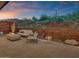 Backyard patio with fire pit, seating, and rusted metal wall at 6525 E Cave Creek Rd # 14, Cave Creek, AZ 85331