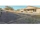 Large backyard with covered patio, firepit, and gravel landscaping at 6910 S 26Th Ln, Phoenix, AZ 85041