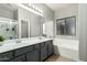 Bathroom with double vanity and soaking tub at 6910 S 26Th Ln, Phoenix, AZ 85041