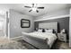 Main bedroom with tufted headboard and ceiling fan at 6910 S 26Th Ln, Phoenix, AZ 85041