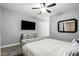 Main bedroom with tufted headboard and ceiling fan at 6910 S 26Th Ln, Phoenix, AZ 85041