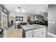 Modern kitchen with island, white cabinets, and granite counters at 6910 S 26Th Ln, Phoenix, AZ 85041