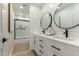 Modern bathroom with double vanity, soaking tub, and walk-in shower at 7489 E Windrose Dr, Scottsdale, AZ 85260