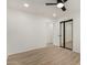 Simple bedroom with wood floors and mirrored closet doors at 7489 E Windrose Dr, Scottsdale, AZ 85260