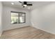 Well-lit bedroom with wood floors and a ceiling fan at 7489 E Windrose Dr, Scottsdale, AZ 85260