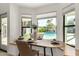 Breakfast nook with built-in bench seating overlooks the pool at 7489 E Windrose Dr, Scottsdale, AZ 85260