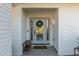 Modern front door with glass panels and a wood bench at 7489 E Windrose Dr, Scottsdale, AZ 85260